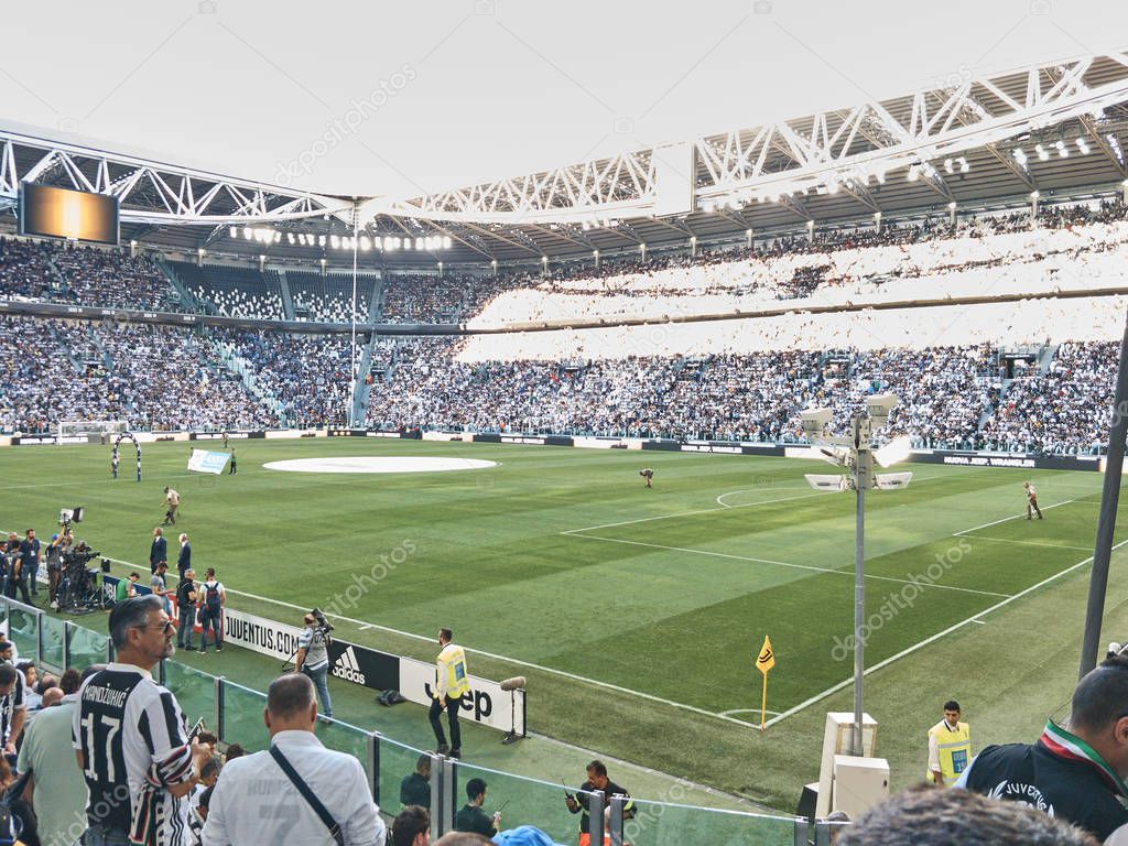 Turin, Italy - September 29, 2018: View of the Allianz Stadium, the field where Juventus plays its home matches. The shot is taken in a sunny day before the Serie A match Juve-Napoli with people waiting for the match to start