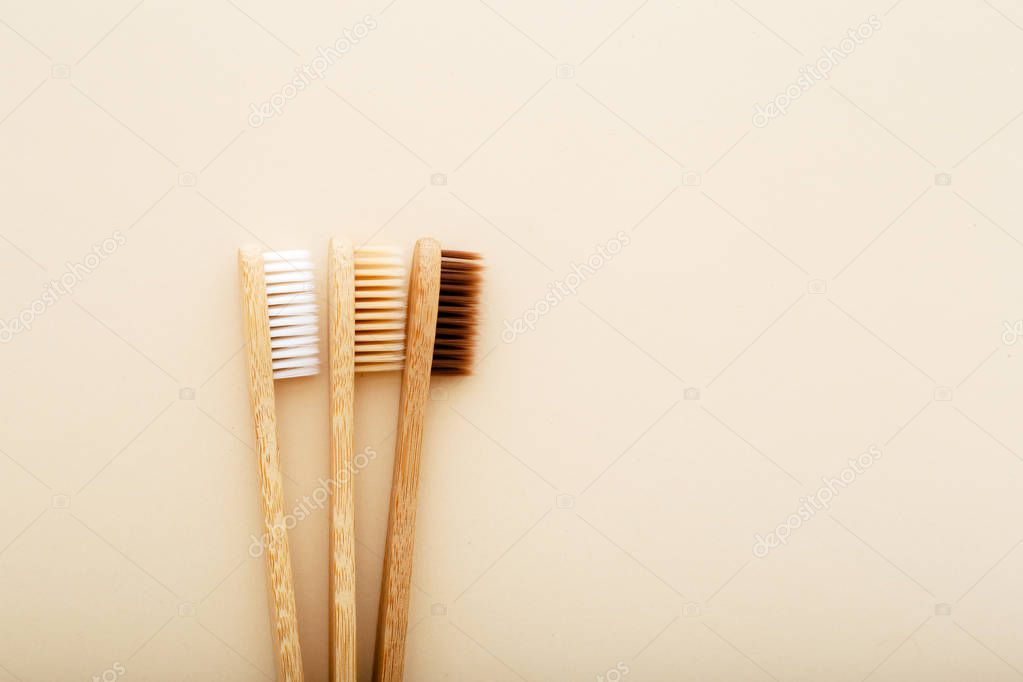 Eco-friendly bamboo tooth brush. Zero waste set on light beige natural background. Flat lay style.