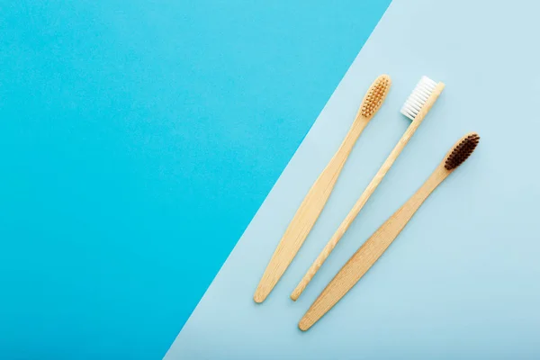 Dental care with eco friendly bamboo toothbrush on blue background top view. Zero waste and plastic free concept. — Stock Photo, Image