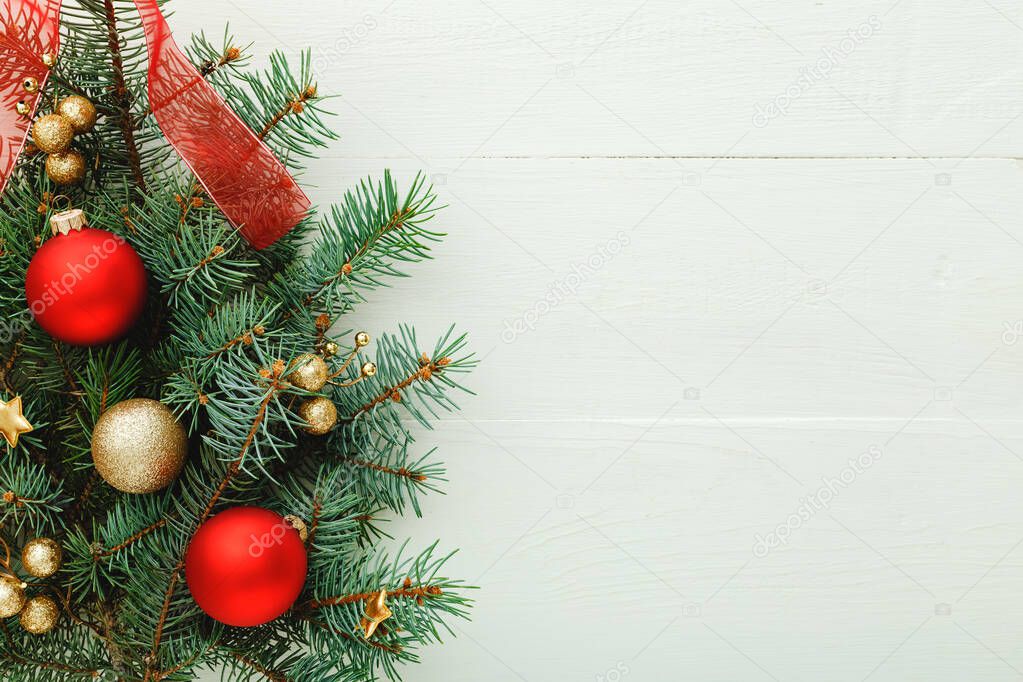 Xmas New Year 2020 holiday celebration pattern composition made of red balls, fir branches on white wooden background. Concept Christmas time, winter. Flat lay, top view, copy space