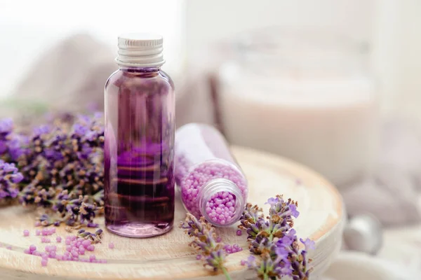 Set lavender bath cosmetics products in bottles with fresh lavender flowers candle soap bath beads. Lavender essential oil, natural spa products.Aromatherapy treatment Copy space