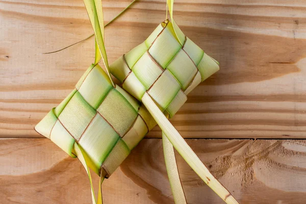 Ketupat woreczki na drewnianym tle — Zdjęcie stockowe