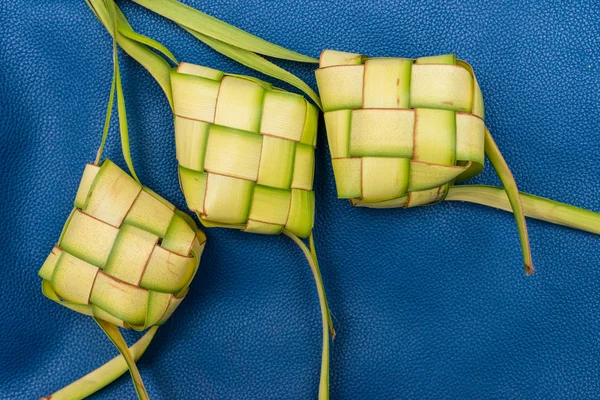 Ketupat Pouches on a blue background. Ketupat is a type of dumpl