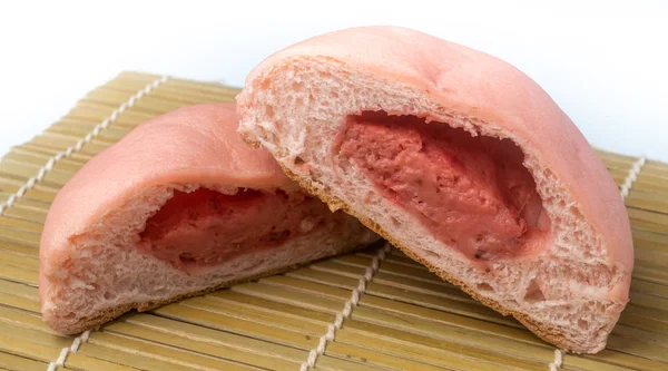 Japanese Snack - Pink Melon Pan on rattan mat. Strawberry Flavor