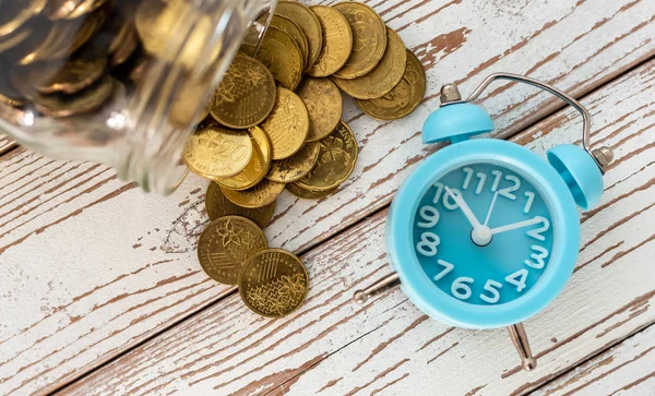 Savings for the future. Malaysia coins and clock on wooden backg — Stock Photo, Image