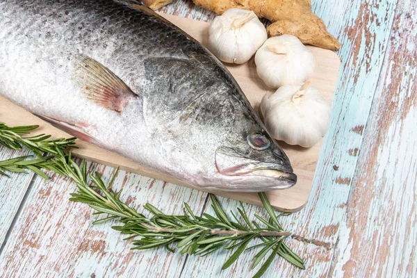 Fresh Sea Bass on wooden table — Stock Photo, Image