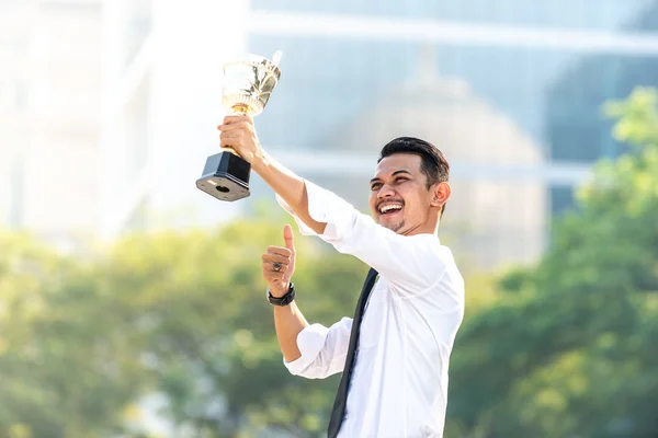 Malay Businessman wins a trophy. Top employee concept