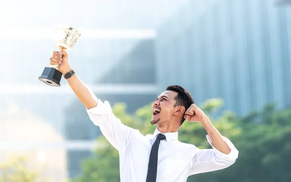 Malay Businessman wins a trophy. Top employee concept