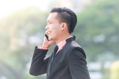 Genç Malay İş Adamı Onun Smartphone konuşuyor. 