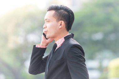 Genç Malay İş Adamı Onun Smartphone konuşuyor. 