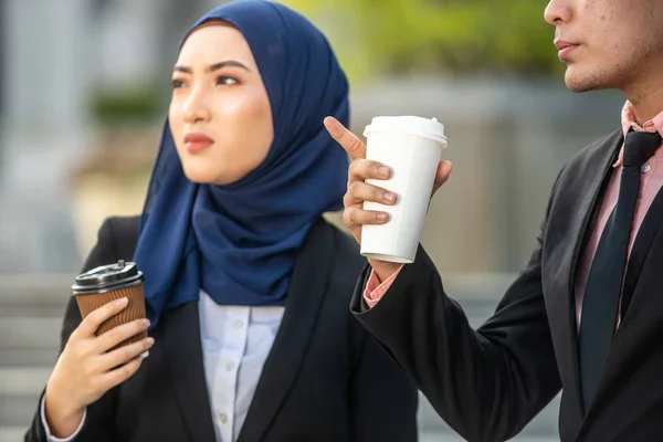 Muslim Businessman and Businesswoman having a conversation durin