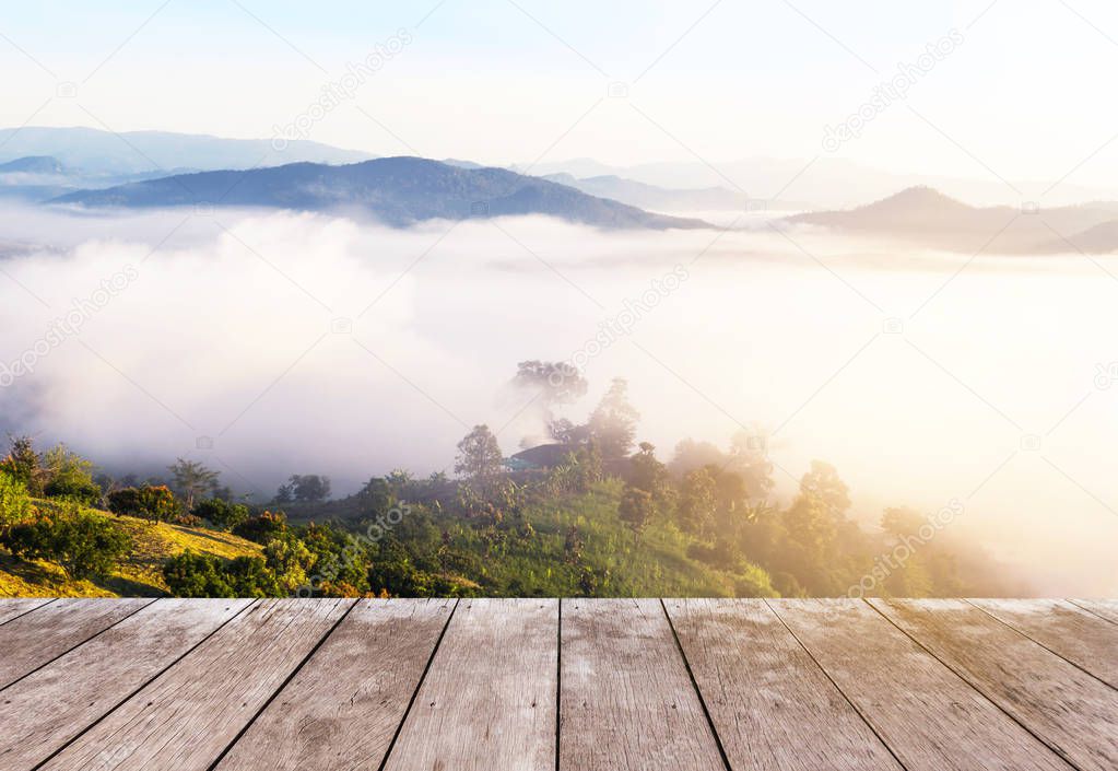 Empty old wooden balcony terrace floor on viewpoint high tropical rainforest layer mountain with white fog in early morning