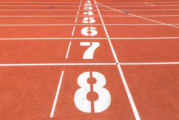 Empty athletic running track lanes texture with number in stadium