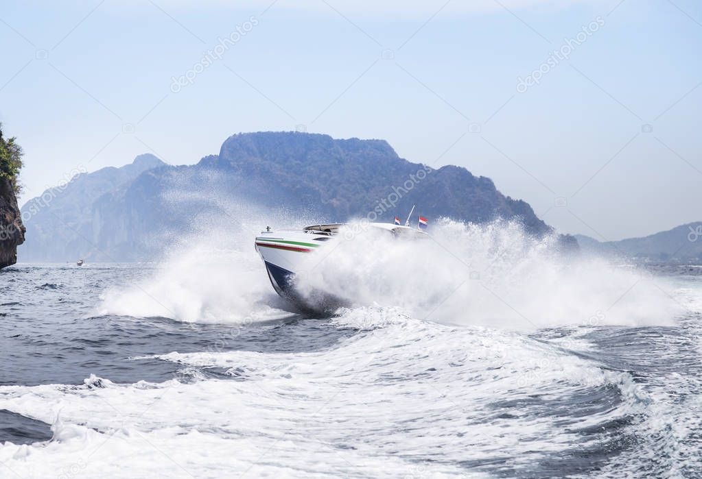 speedboat or motorboat sailing on white wave in the tropical sea