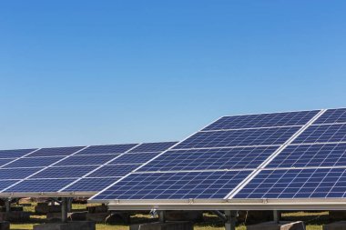 Close up rows array of polycrystalline silicon solar cells or photovoltaic cells in solar power plant station turn up skyward absorb the sunlight from the sun alternative renewable energy from the sun  clipart