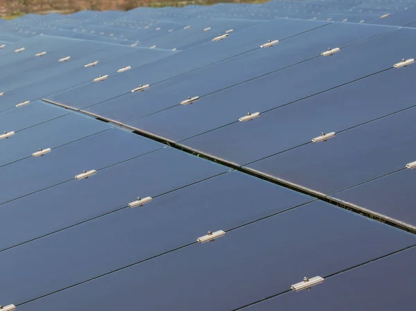 Close up array of  thin film solar cells or amorphous silicon solar cells or photovoltaics in solar power plant turn up skyward absorb the sunlight from the sun use light energy to generate electricity