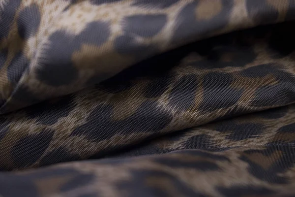 close up view of leopard patterned fabric as background