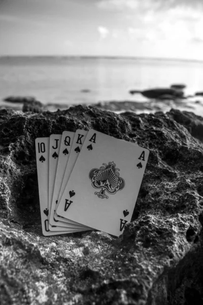 royal flush spade poker cards on beach, gamble theme