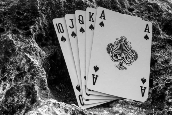 royal flush spade poker cards on beach, gamble theme