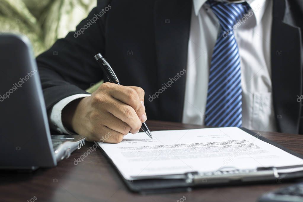 businessman or lawyer signing on contract paper on table in office, concept as insurance and manager