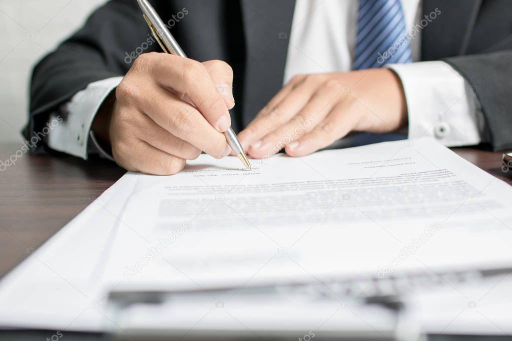 businessman or lawyer signing on contract paper on table in office, concept as insurance and manager