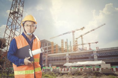 Akıllı mühendis büyük bina arka plan ile inşaat sitesinde