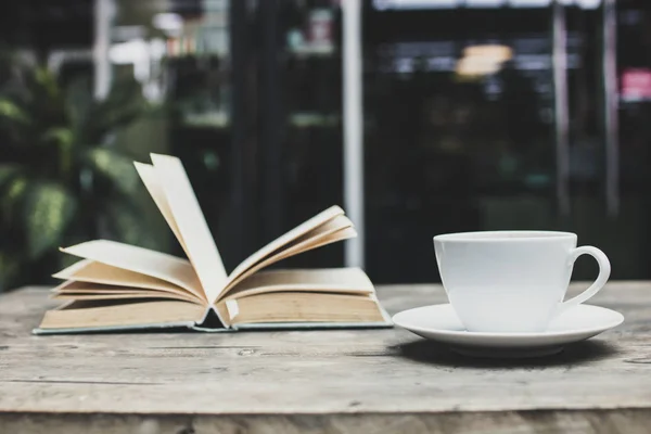 coffee and book on table in cafe