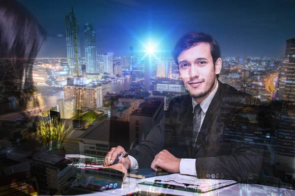 smart businessman in office with night city background