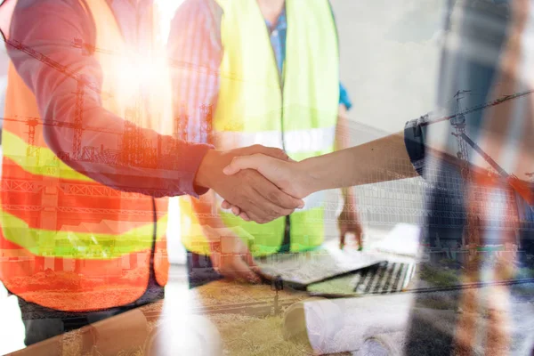 construction worker shake hands as meeting