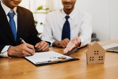 Real estate concept, business man signing house insurance contra