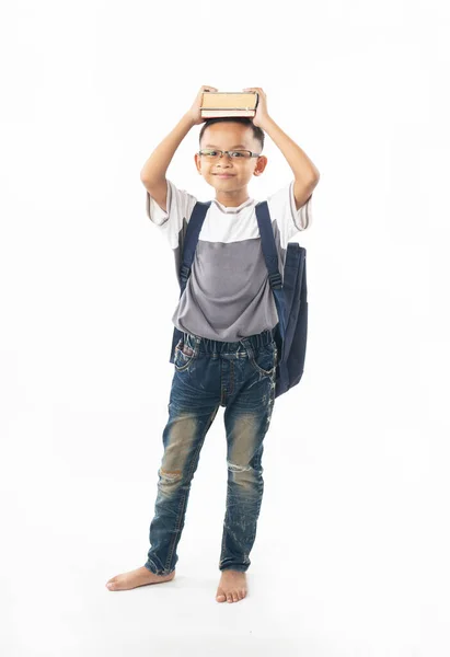 Jovem asiático menino estudante segurando livro e mostrar sobre a cabeça, isolar — Fotografia de Stock