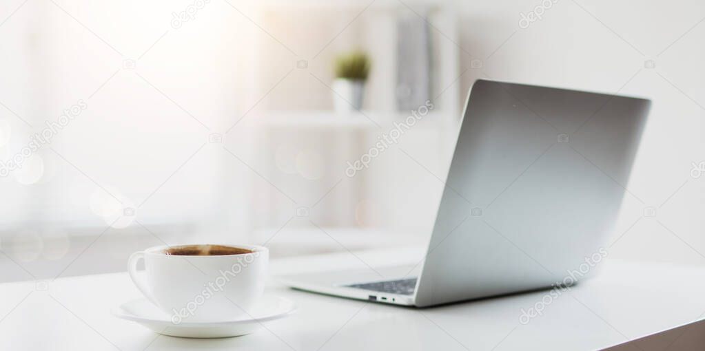 cup of coffee on working table with laptop