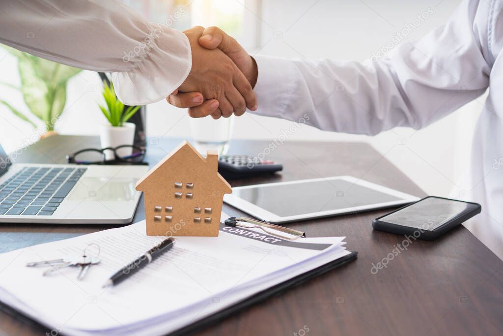 broker residential house shake hand with customer after successful agreement and signing house contract, real estate concept