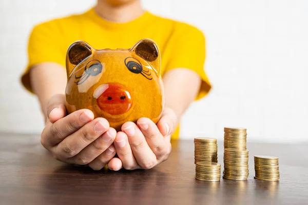 close up woman holding piggy bank, present to save and change money credit