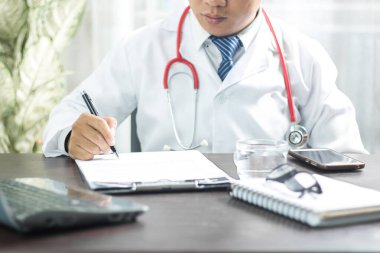 Working space of Doctor with stethoscope with medicine tablet and notebook for consult patient