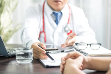 Working space of Doctor with stethoscope with medicine tablet and notebook for consult patient
