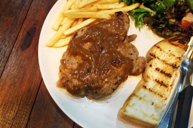 ahşap masa üzerinde domuz eti biftek