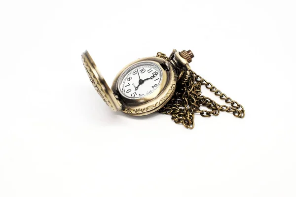 An ancient pocket watch on a white background.