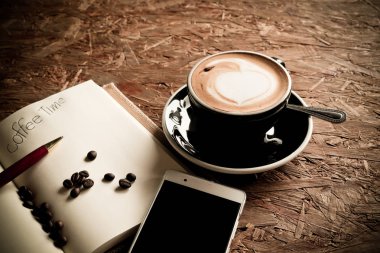 Sıcak kahve, kahve çekirdekleri, defter vintage tarzı.