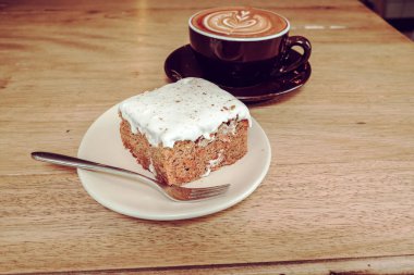 Sıcak latte kahve ile havuç Cheesecake ahşap tablo