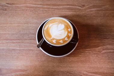 Ahşap zemin üzerinde sıcak Latte Kahve