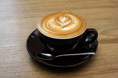 Ahşap bir masa üzerinde sıcak kahve Latte.