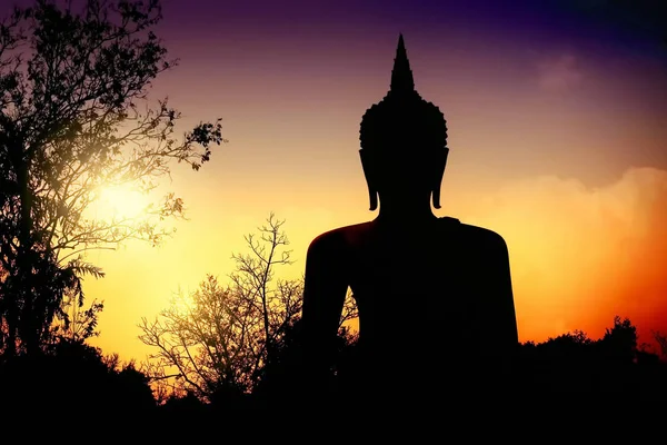 silhouette of Buddha statue during sunset