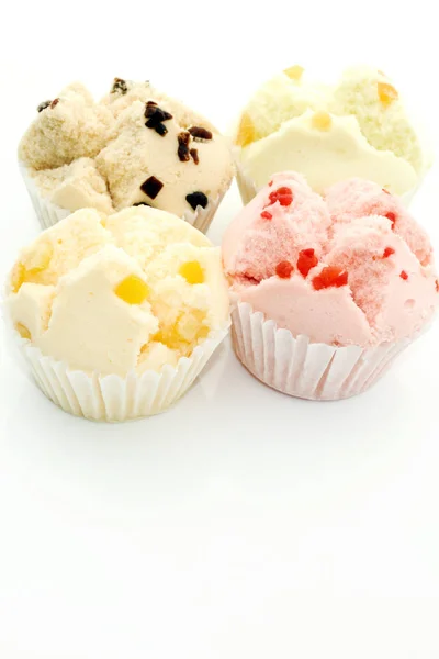 Close up of colorful cupcakes on white background