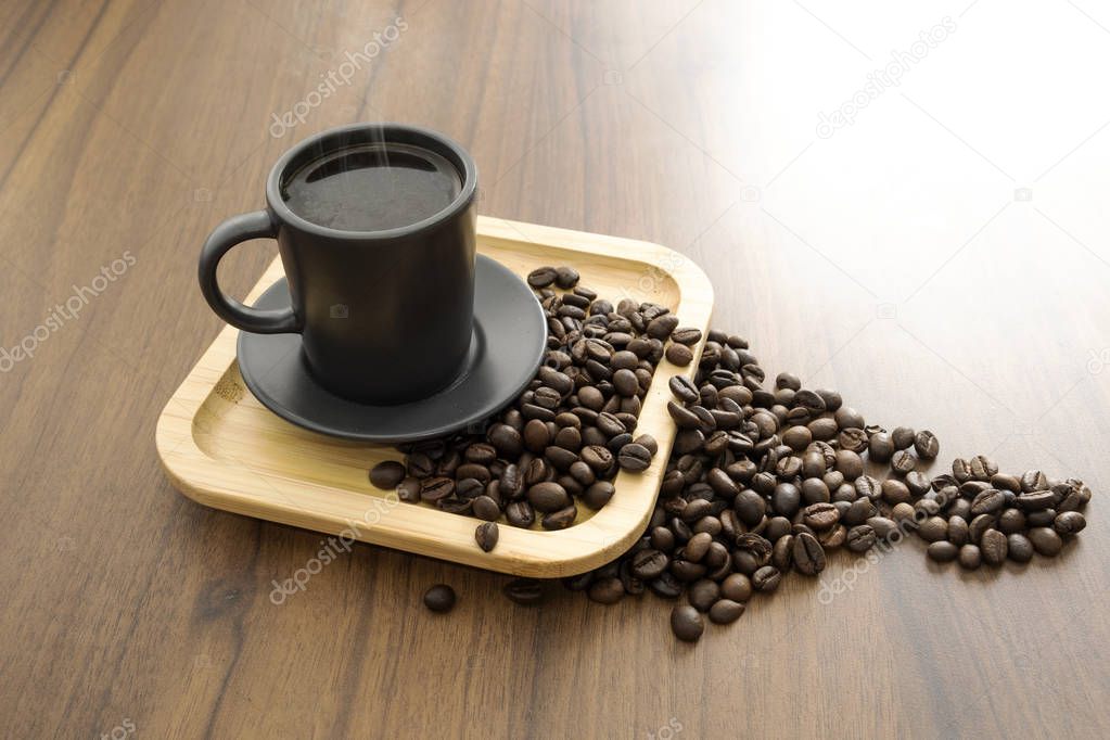 Hot coffee and coffee beans on wooden floors
