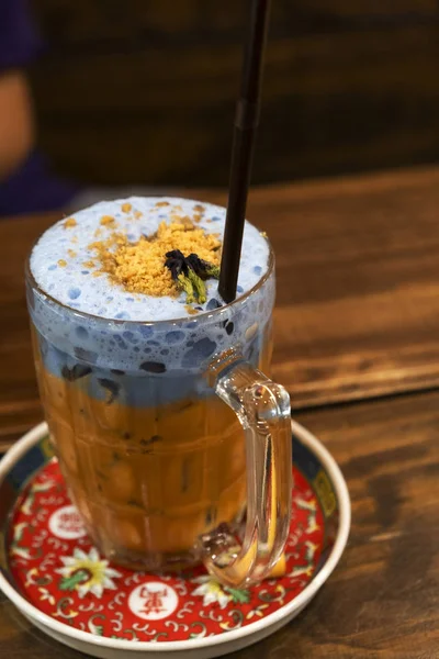 Thailand ice tea mixed with milk blue on a dark background.