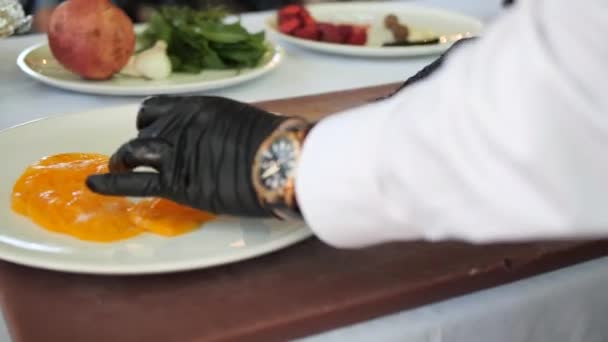 Chef Con Guantes Negros Corta Tomates Amarillos Los Extiende Plato — Vídeos de Stock