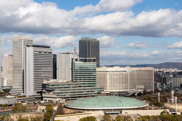 OSAKA , JAPAN - February 1, 2019 : Osaka city scape at daytime . Taken a photo from view point on highest of osaka castle . Obviously seen Osaka-Jo hall ( green dome ) and many building