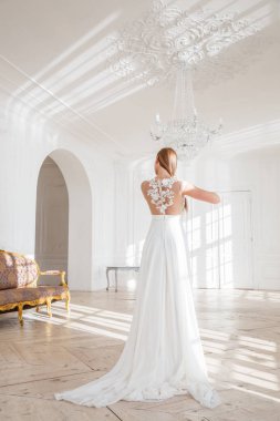 Güzel sarışın kadın beyaz iç arka plan ayakta beyaz elbise moda çekim