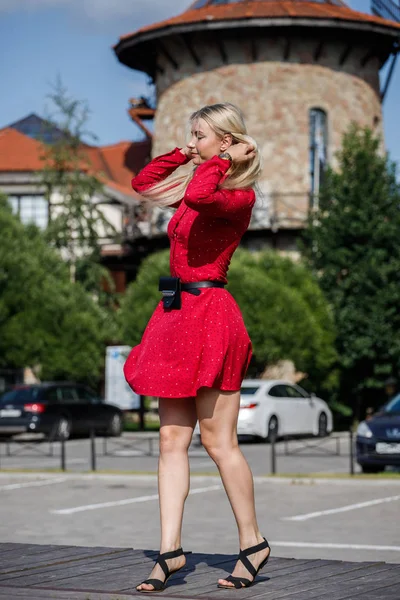 昼間の街の赤いドレスで金髪美人のアウトドアファッションの肖像画 — ストック写真